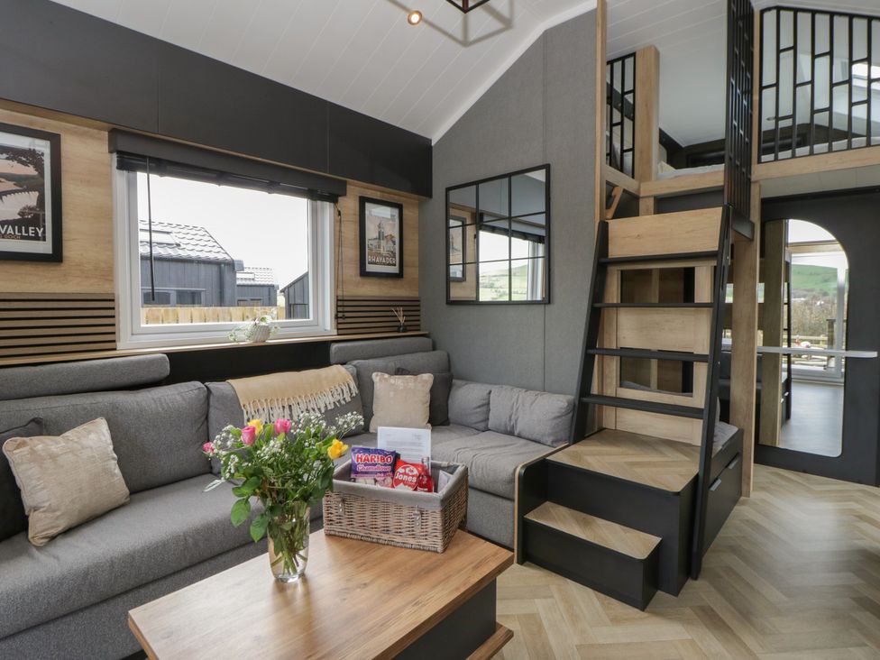 A living room with a sofa and stairs at Daverneithon 2 near Llandrindod Wells