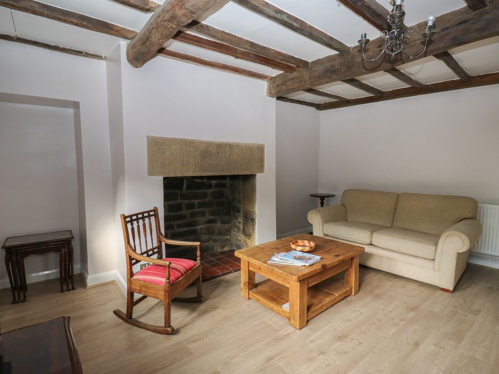 A living room with a sofa and coffee table at 11 Hollin Well Cottage Sowerby Bridge