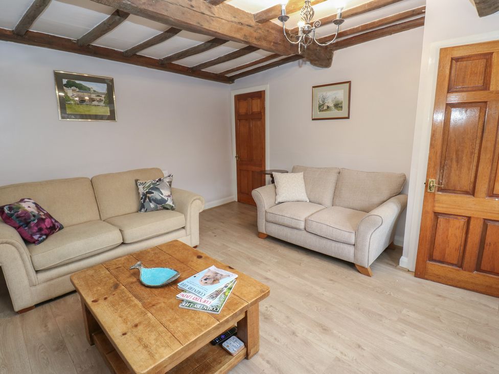 A living room with sofas and a coffee table at 11 Hollin Well Cottage in Sowerby Bridge