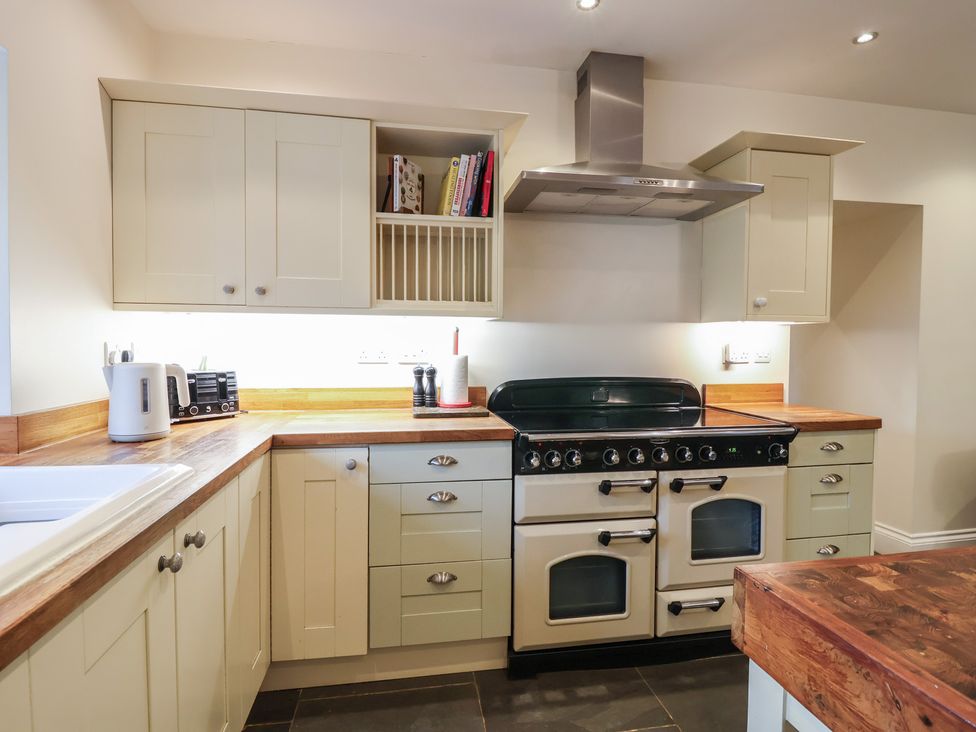A kitchen with storage cabinets and an oven at The Old Manor House in Lifton