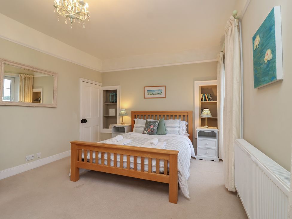 A bedroom with a bed and nightstand at The Old Manor House in Lifton