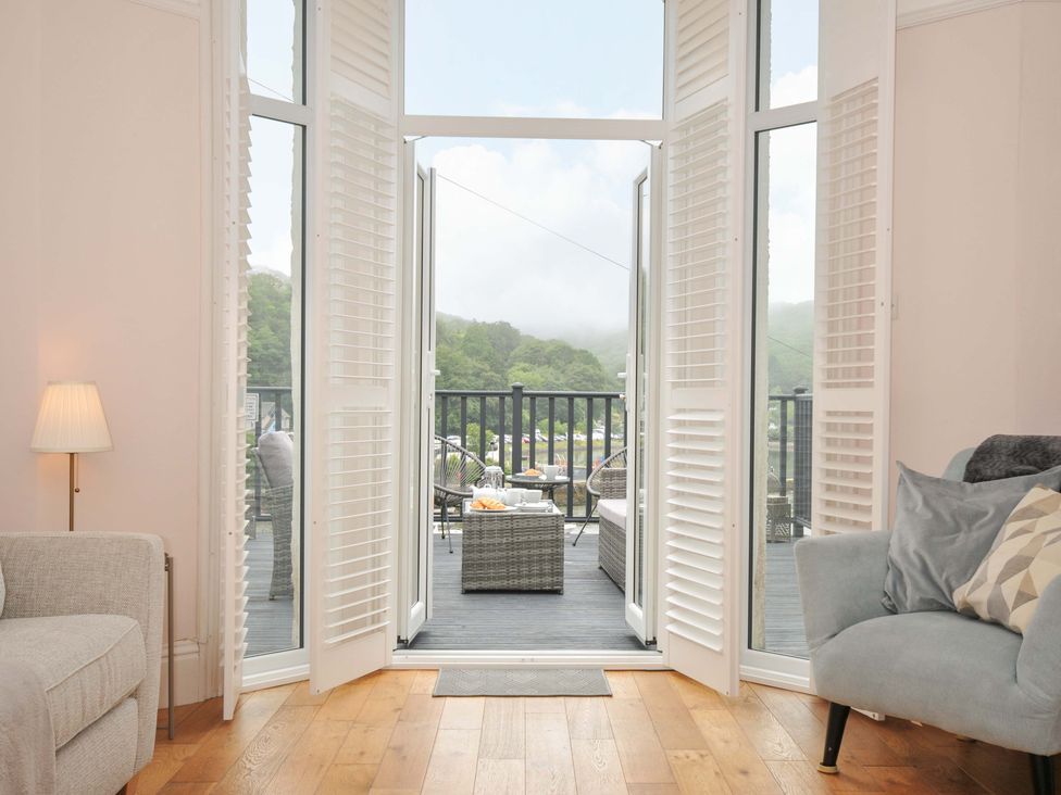 A living room with couches and doors leading to a deck at Overdale