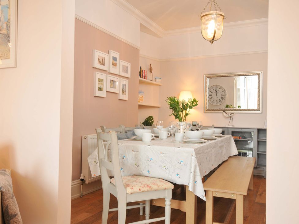 A dining room with a table set for meals at Overdale