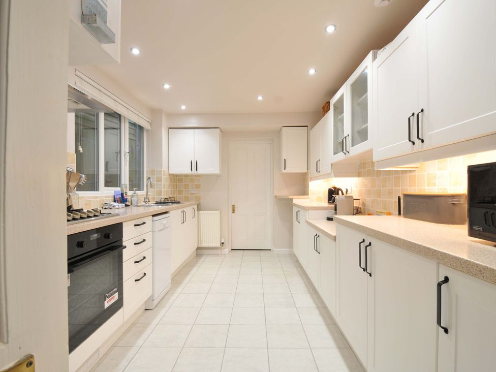 A kitchen with cabinets and appliances at Overdale
