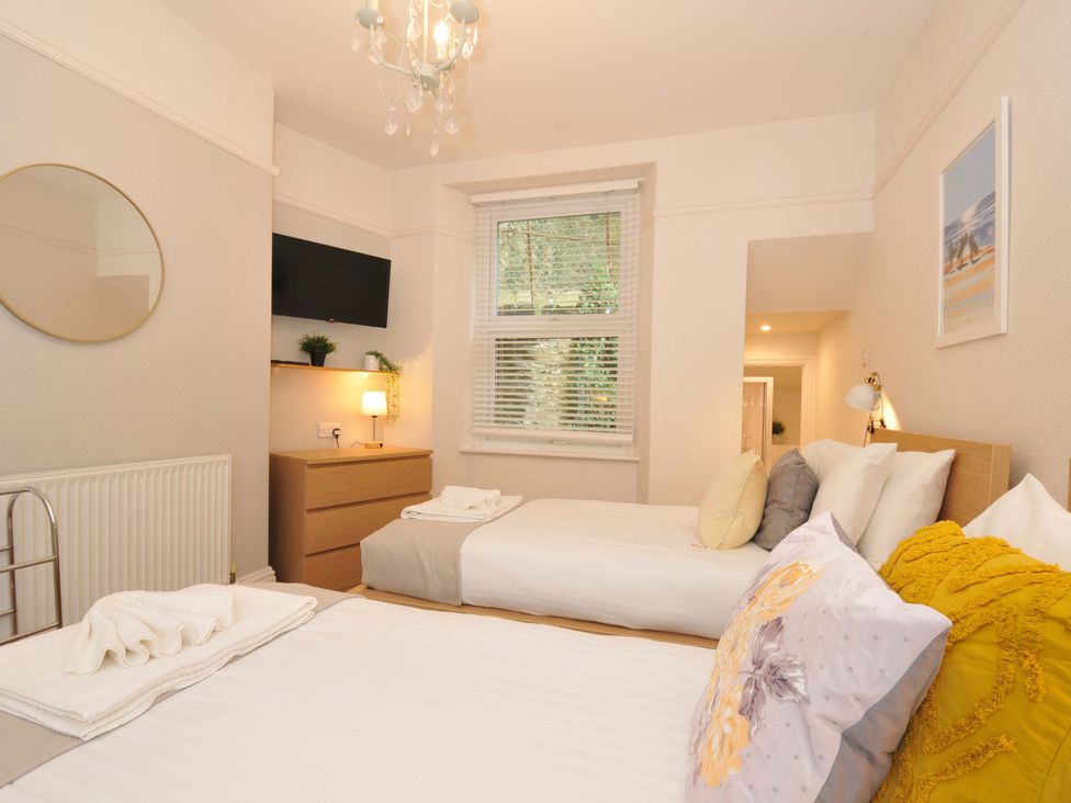 A bedroom with two beds and a dresser at Overdale