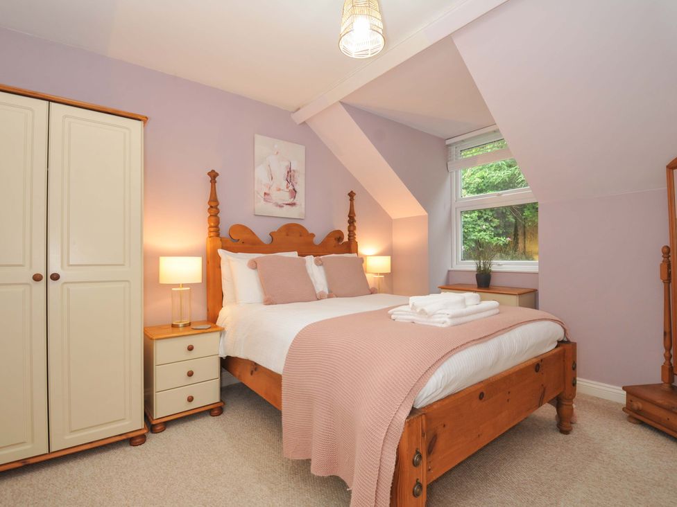 A bedroom with a bed and wardrobe at Overdale