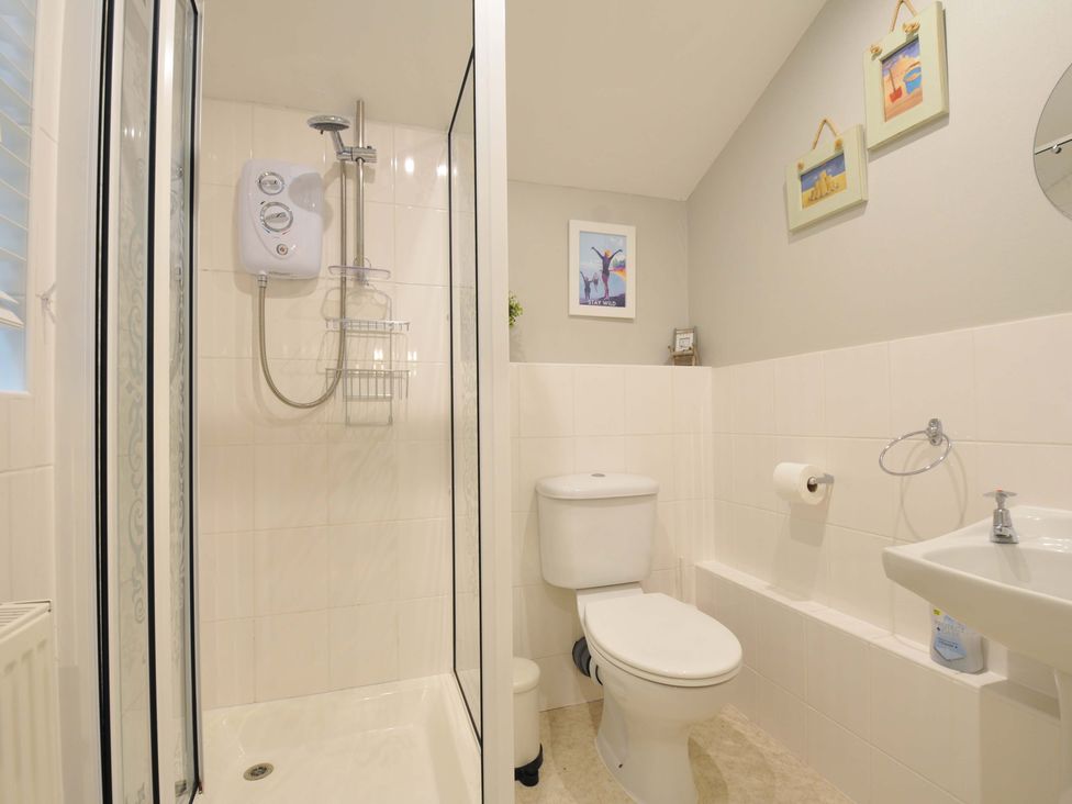 A bathroom with a shower, toilet, and sink at Overdale