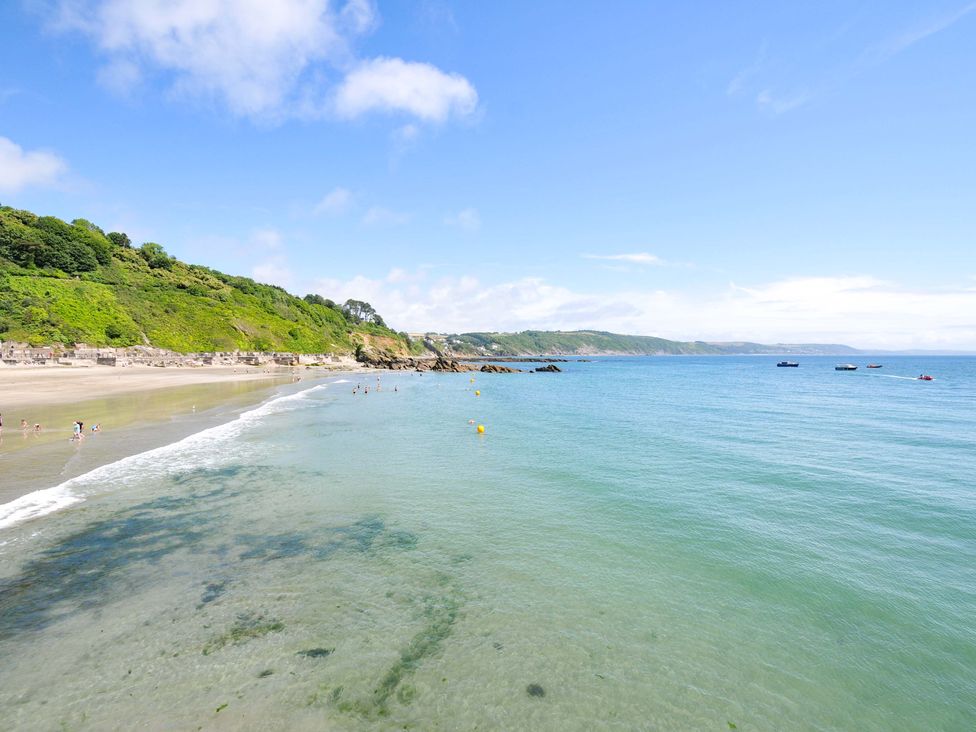A beach with clear water and cliffs in the background at Overdale
