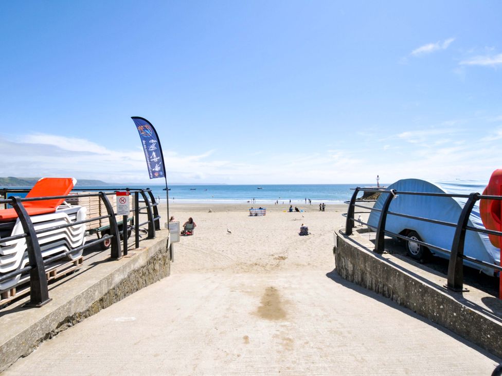 A beach scene with sunbeds and people at Overdale