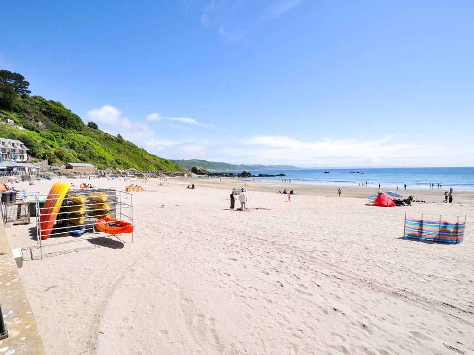 A beach with people and boats at Overdale in 