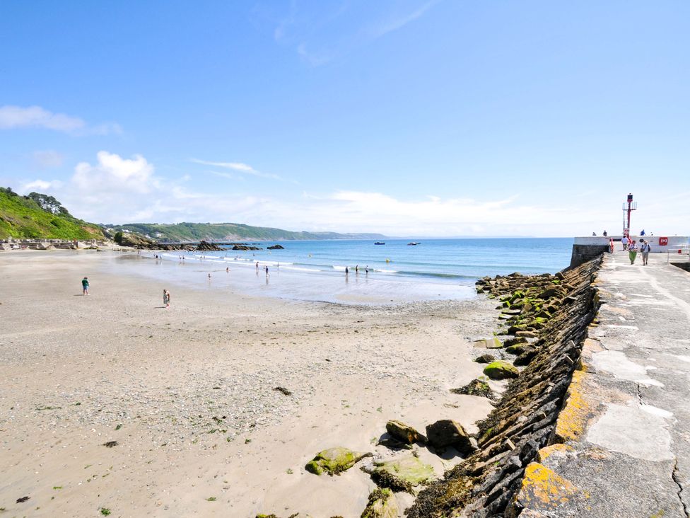 A beach view with people walking along the shore at Overdale