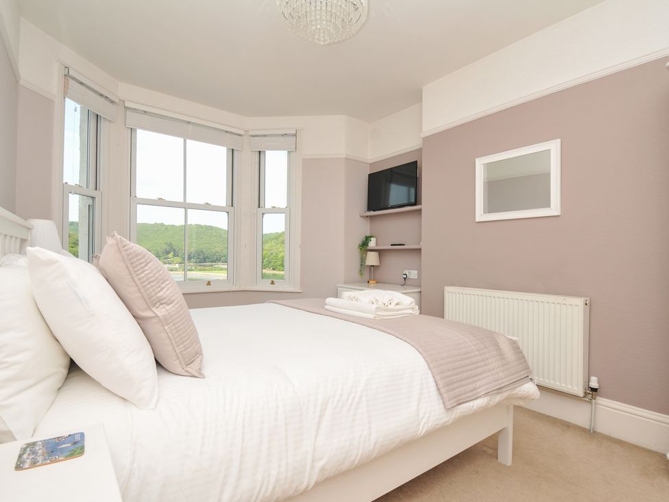 A bedroom with a bed and television at Overdale in Looe