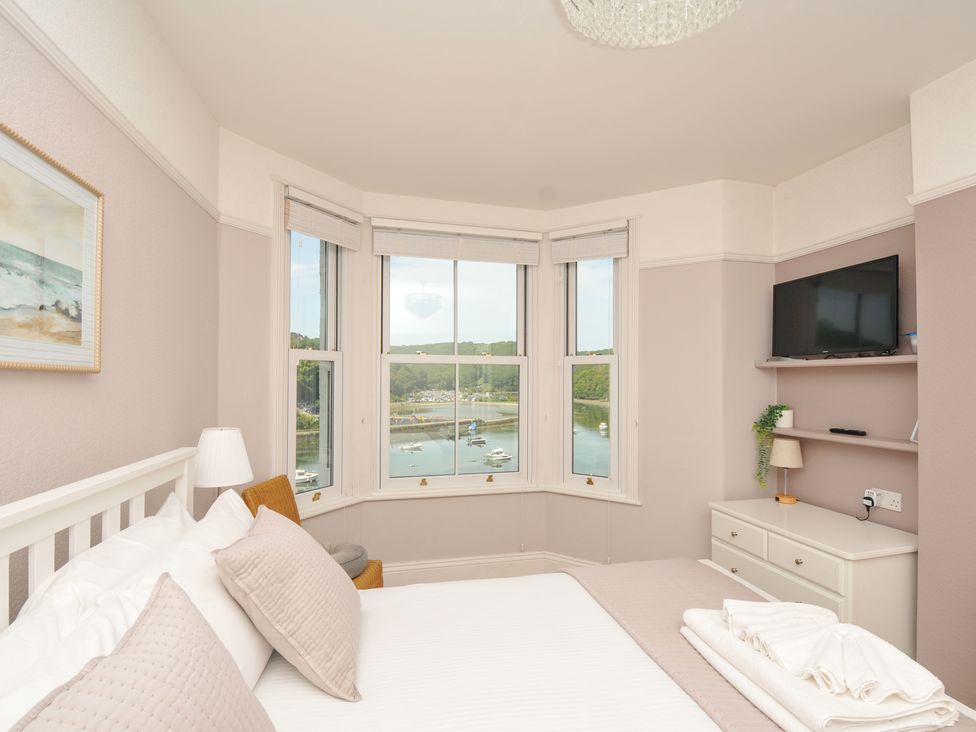 A bedroom with a view of a harbor at Overdale in Looe
