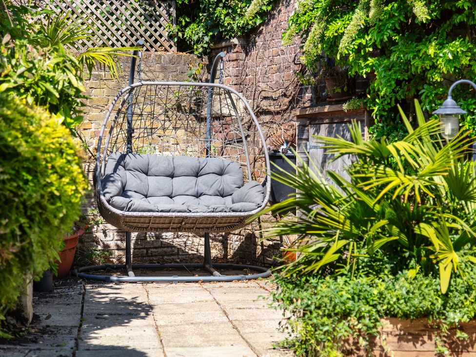 A hanging chair in a garden at Castle View in Windsor, Berkshire