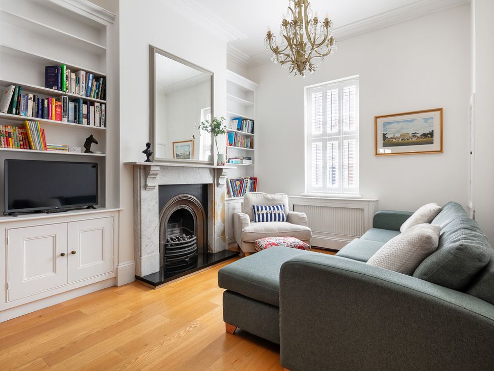 A living room with a television and a fireplace at Castle View in Windsor, Berkshire