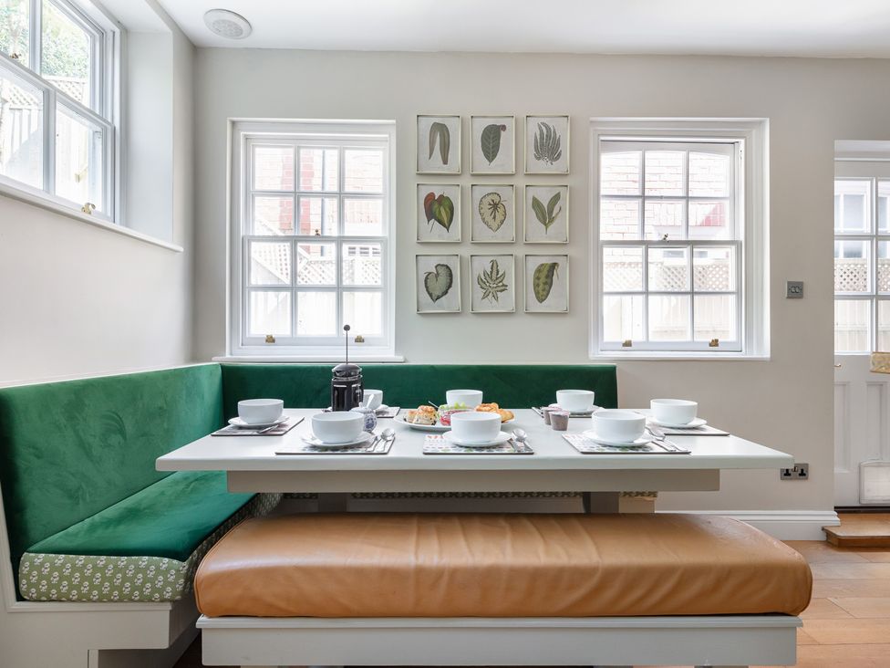 A dining room with a table set for breakfast at Castle View in Windsor, Berkshire