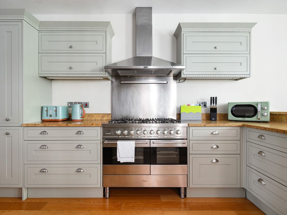 A kitchen with cabinets and appliances at Castle View in Windsor, Berkshire