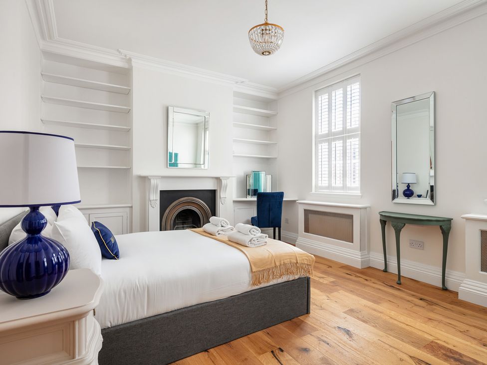 A bedroom with a bed and lamp at Castle View in Windsor, Berkshire