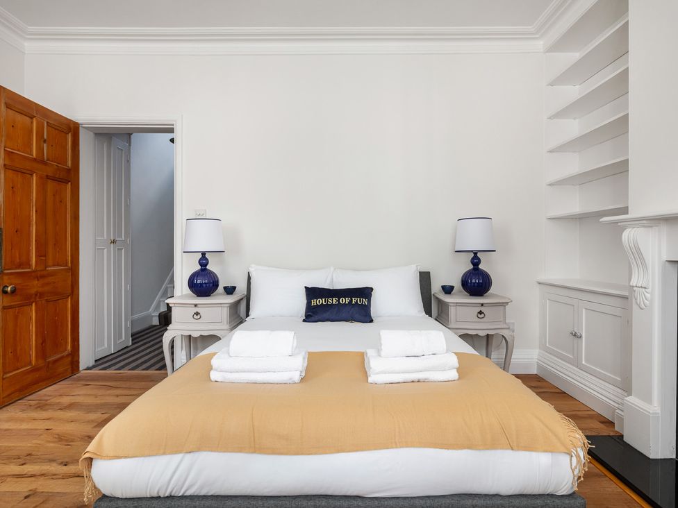 A bedroom with a bed and nightstand at Castle View in Windsor, Berkshire