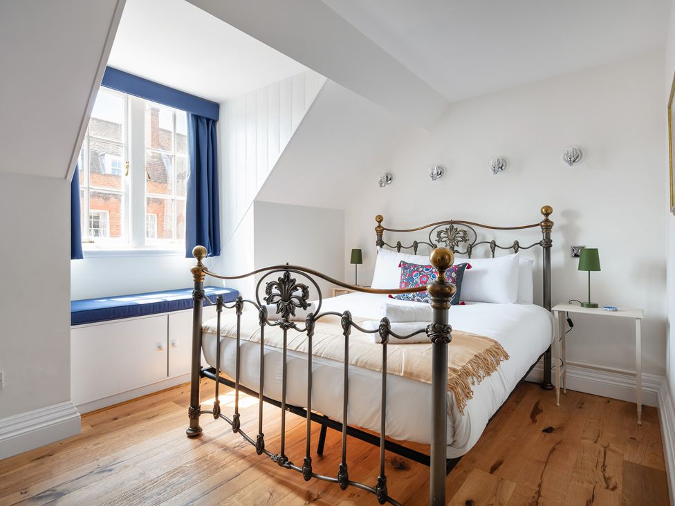 A bedroom with a bed and window at Castle View in Windsor, Berkshire
