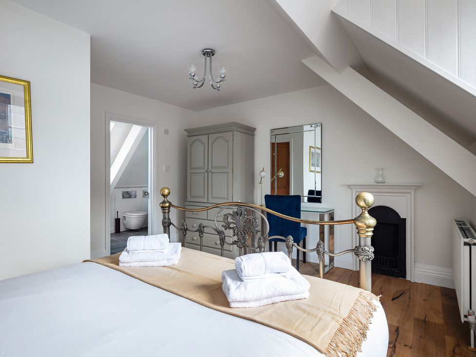 A bedroom with a bed and wardrobe at Castle View in Windsor, Berkshire