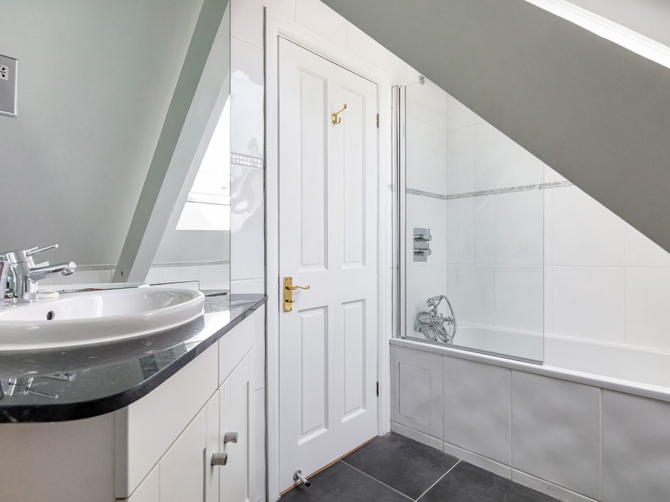 A bathroom with a sink and bathtub at Castle View in Windsor, Berkshire