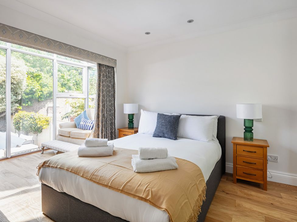 A bedroom with a bed and a sofa at Castle View in Windsor, Berkshire