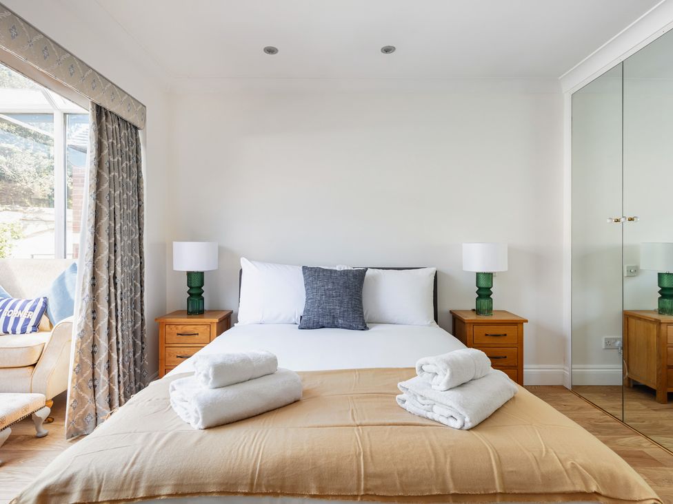 A bedroom with a bed and nightstands at Castle View in Windsor, Berkshire