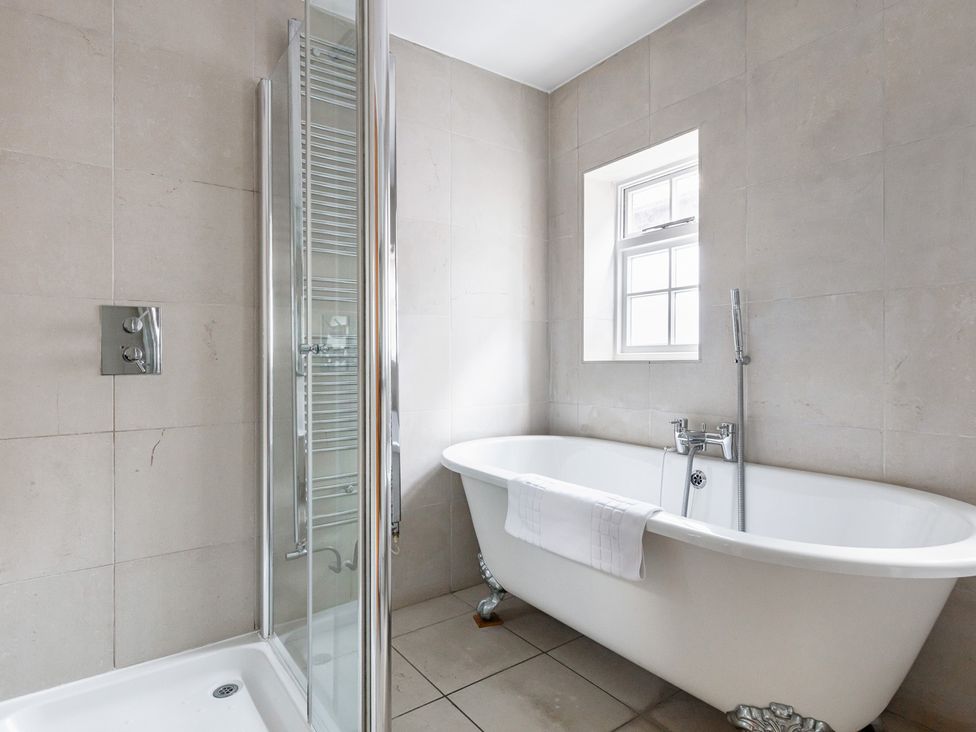 A bathroom with a bathtub and a shower at Castle View in Windsor, Berkshire