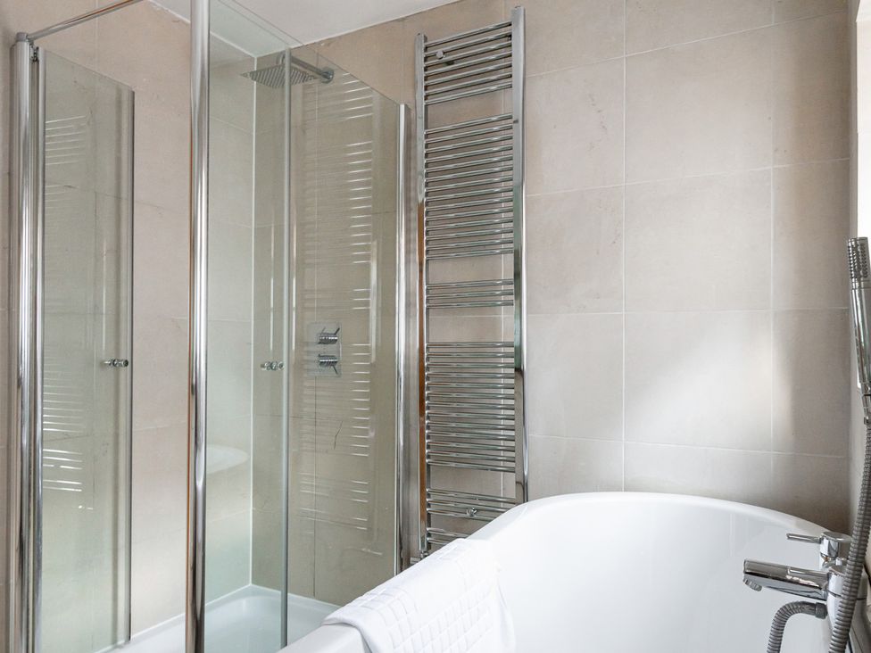 A bathroom with a bathtub and shower enclosures at Castle View, Windsor, Berkshire