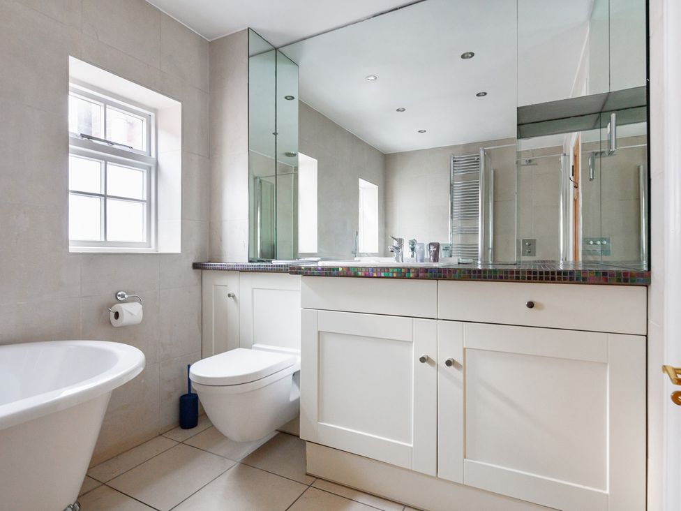 A bathroom with a bathtub and toilet at Castle View in Windsor, Berkshire