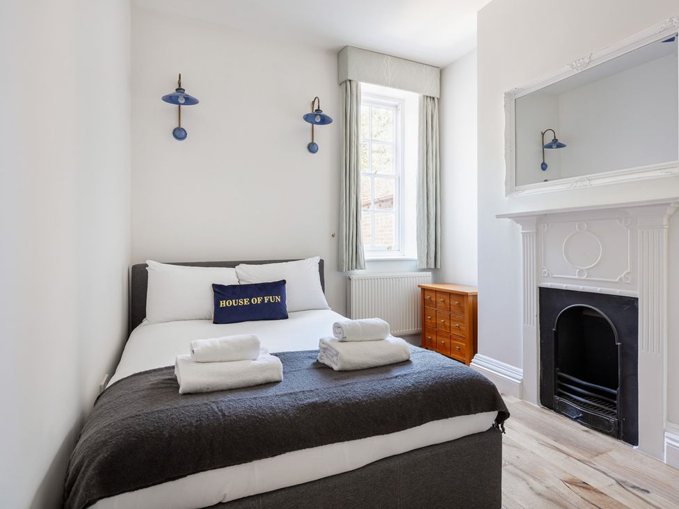 A bedroom with a bed and furniture at Castle View in Windsor, Berkshire