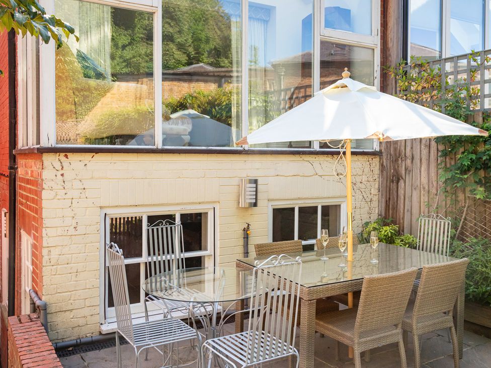 An outdoor seating area with a table and chairs at Castle View in Windsor, Berkshire