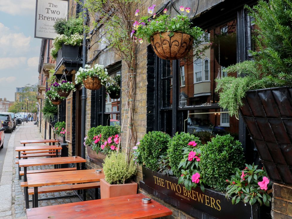 An outdoor area with tables and plants at The Two Brewers in Windsor, Berkshire