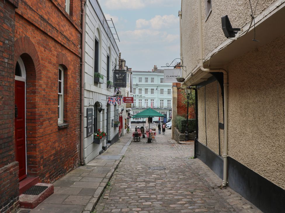 A cobblestone street with buildings and outdoor seating at Castle View in Windsor, Berkshire