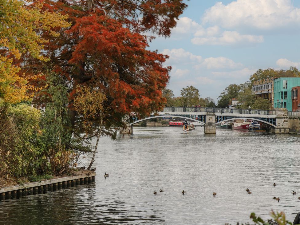 A view of a bridge over water with boats and ducks at Castle View, Windsor, Berkshire