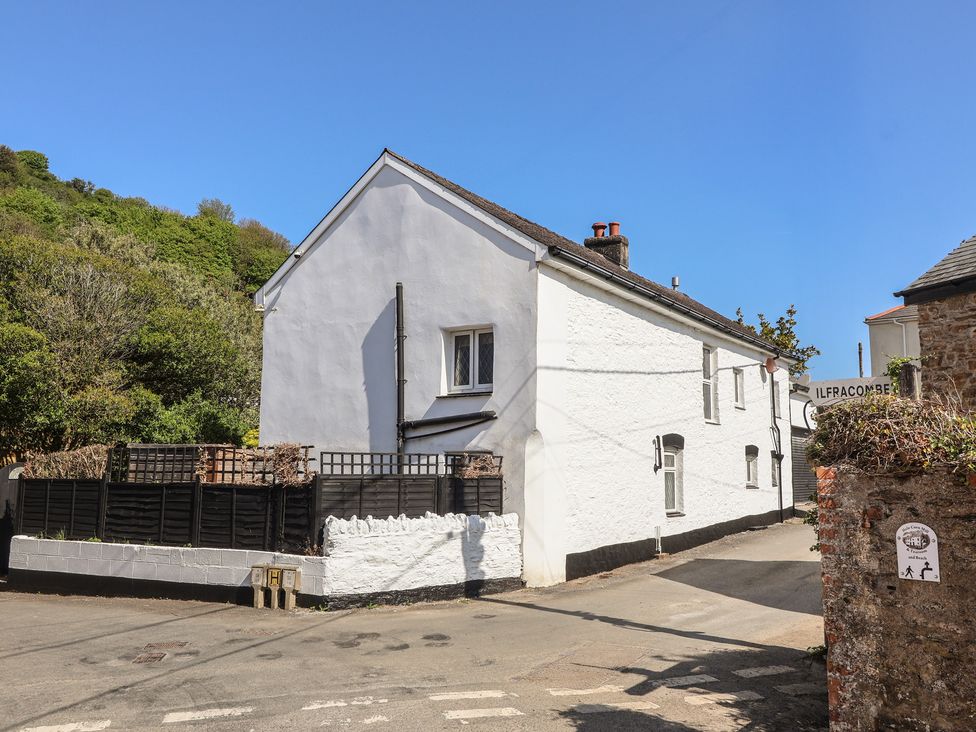 A house with a fence near a road at Honey Cottage Ilfracombe