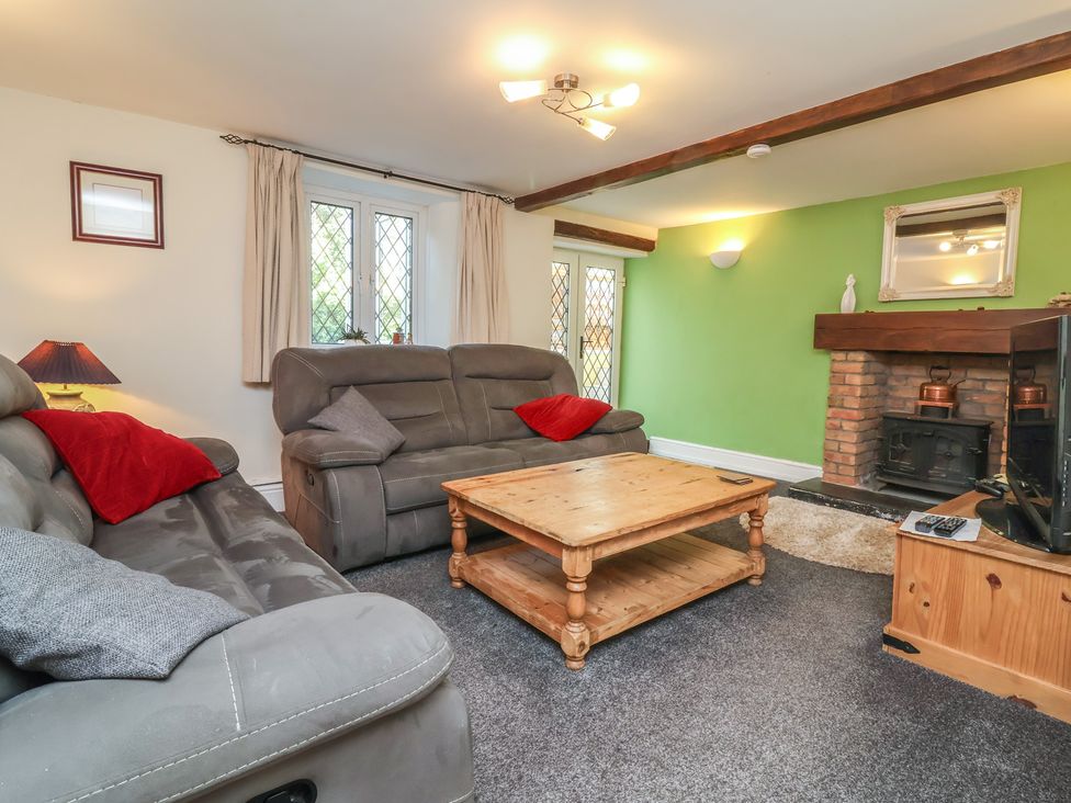 A living room with a sofa and a coffee table at Honey Cottage Ilfracombe