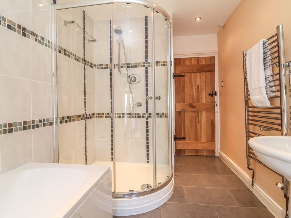 A bathroom with a shower and sink at Honey Cottage in Ilfracombe