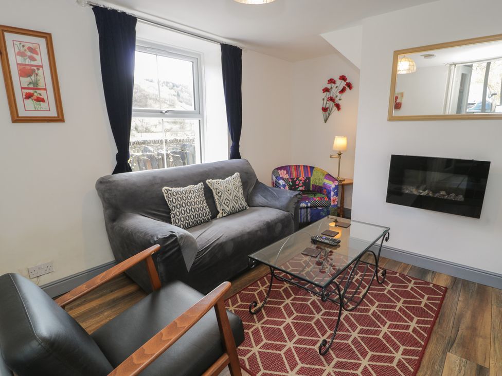 A living room with a sofa and coffee table at Ysgoldy in Dolwyddelan