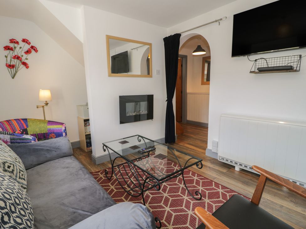 A living room with a sofa and coffee table at Ysgoldy in Dolwyddelan