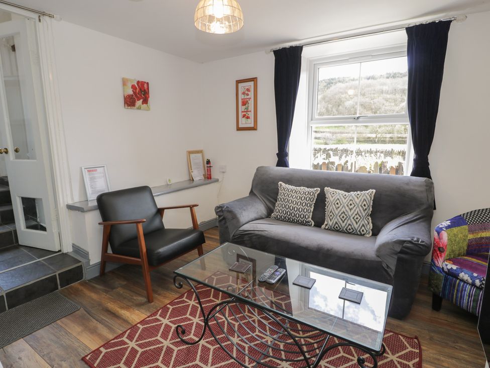 A living room with a sofa and coffee table at Ysgoldy in Dolwyddelan