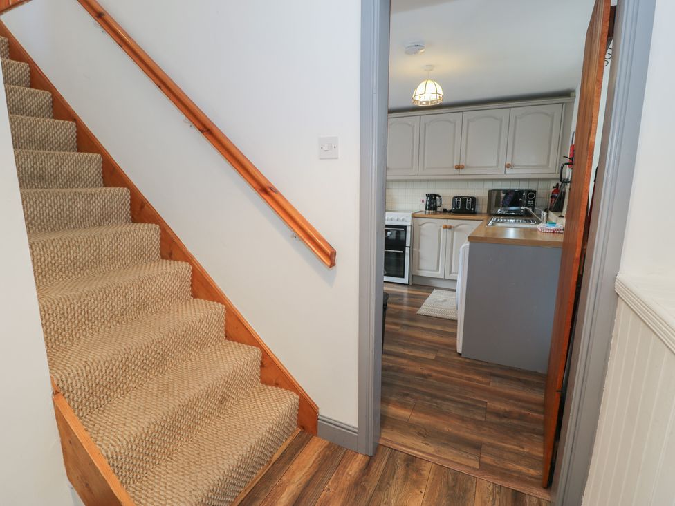 A staircase leading to a kitchen area at Ysgoldy in Dolwyddelan