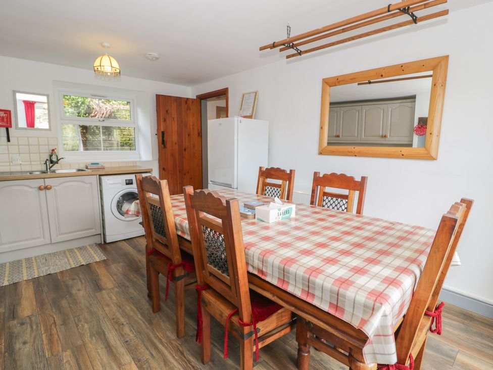 A kitchen with a dining table and chairs at Ysgoldy in Dolwyddelan