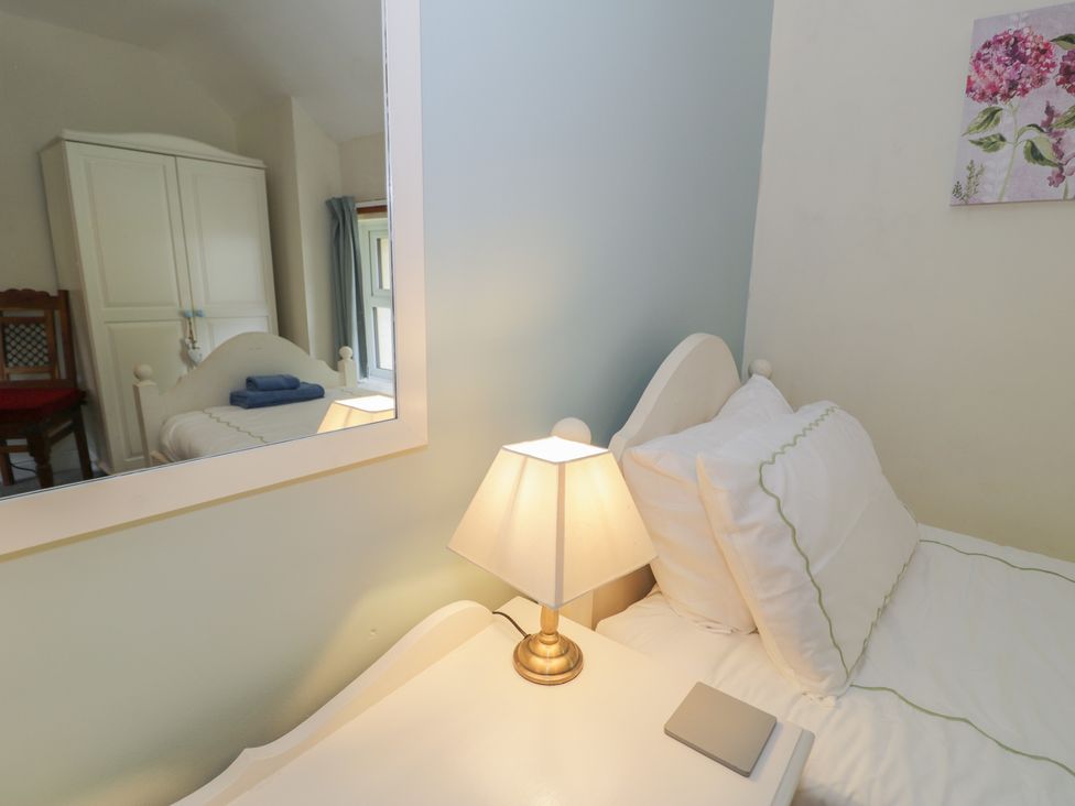 A bedroom with a bed and a wardrobe at Ysgoldy in Dolwyddelan