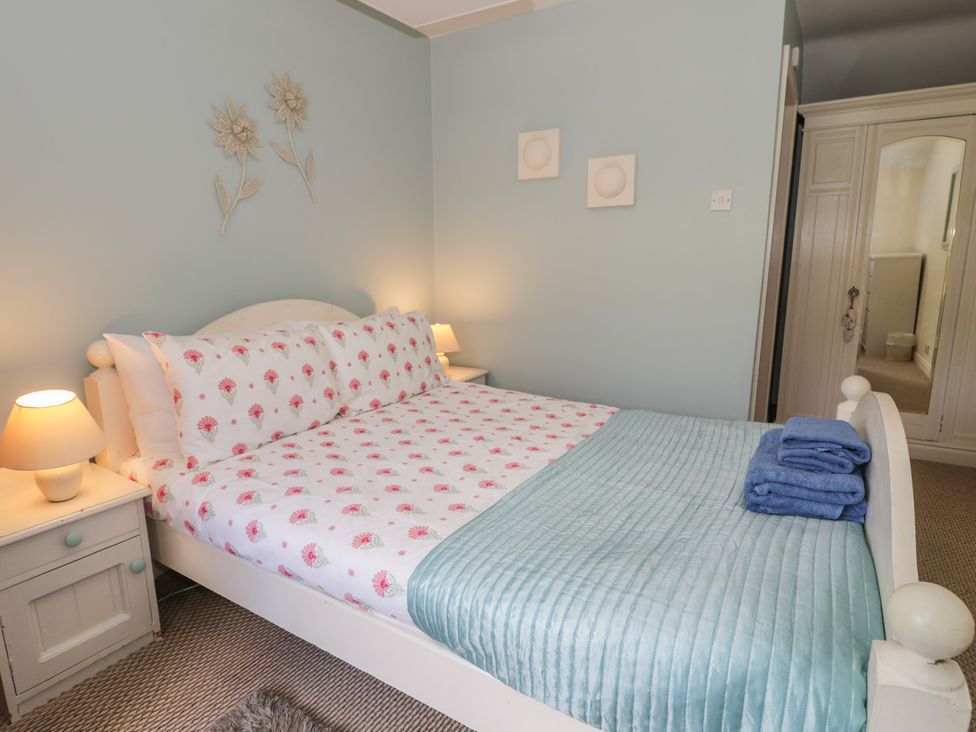 A bedroom with a bed and bedside table at Ysgoldy in Dolwyddelan