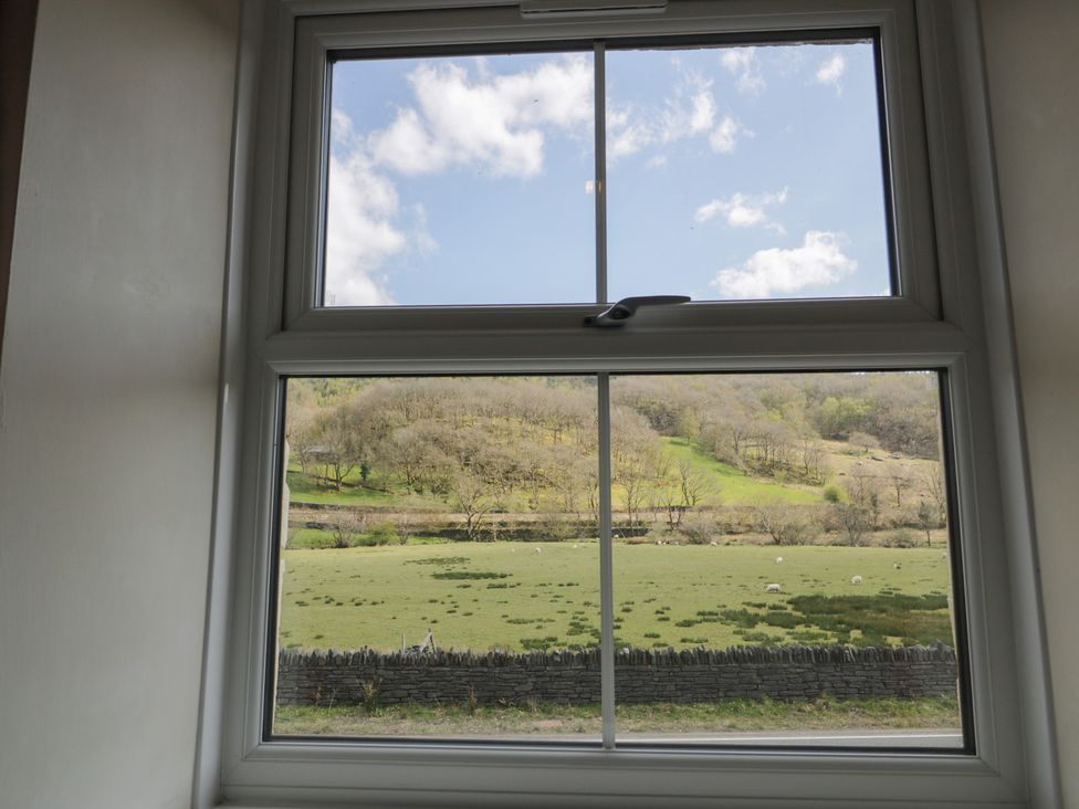 A window view of a field with sheep and mountains at Ysgoldy in Dolwyddelan