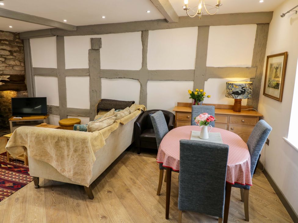 A living room with a sofa and dining table at Middle Cottage in Ludlow