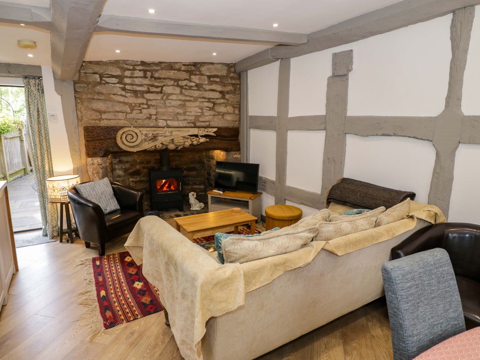 A living room with a fireplace and sofa at Middle Cottage in Ludlow