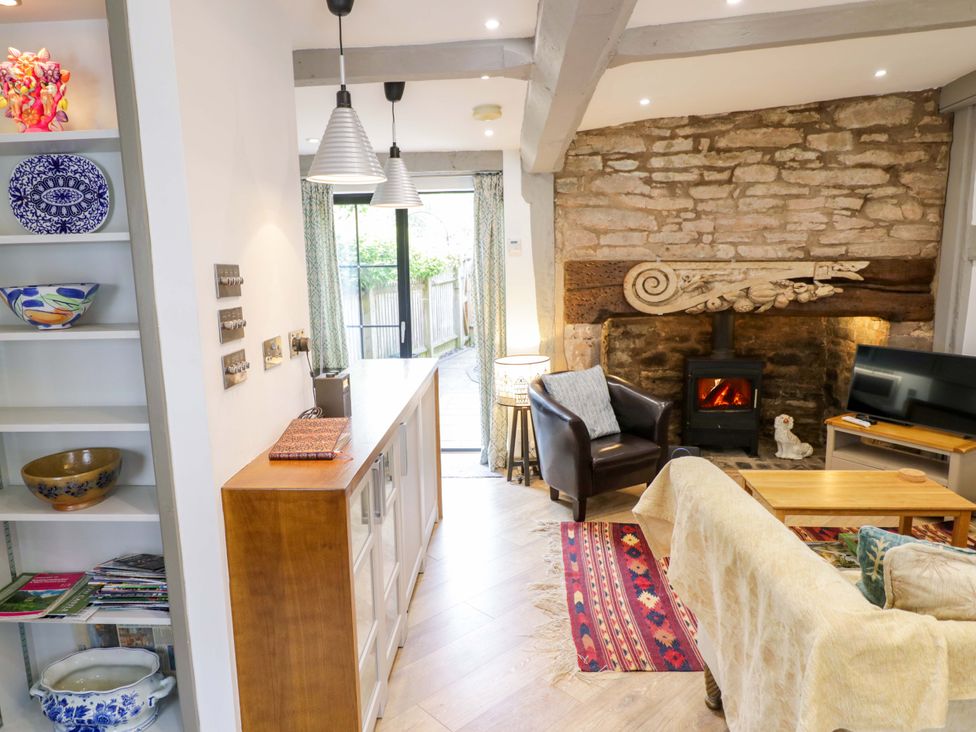 A living room with a fireplace and sofa at Middle Cottage in Ludlow